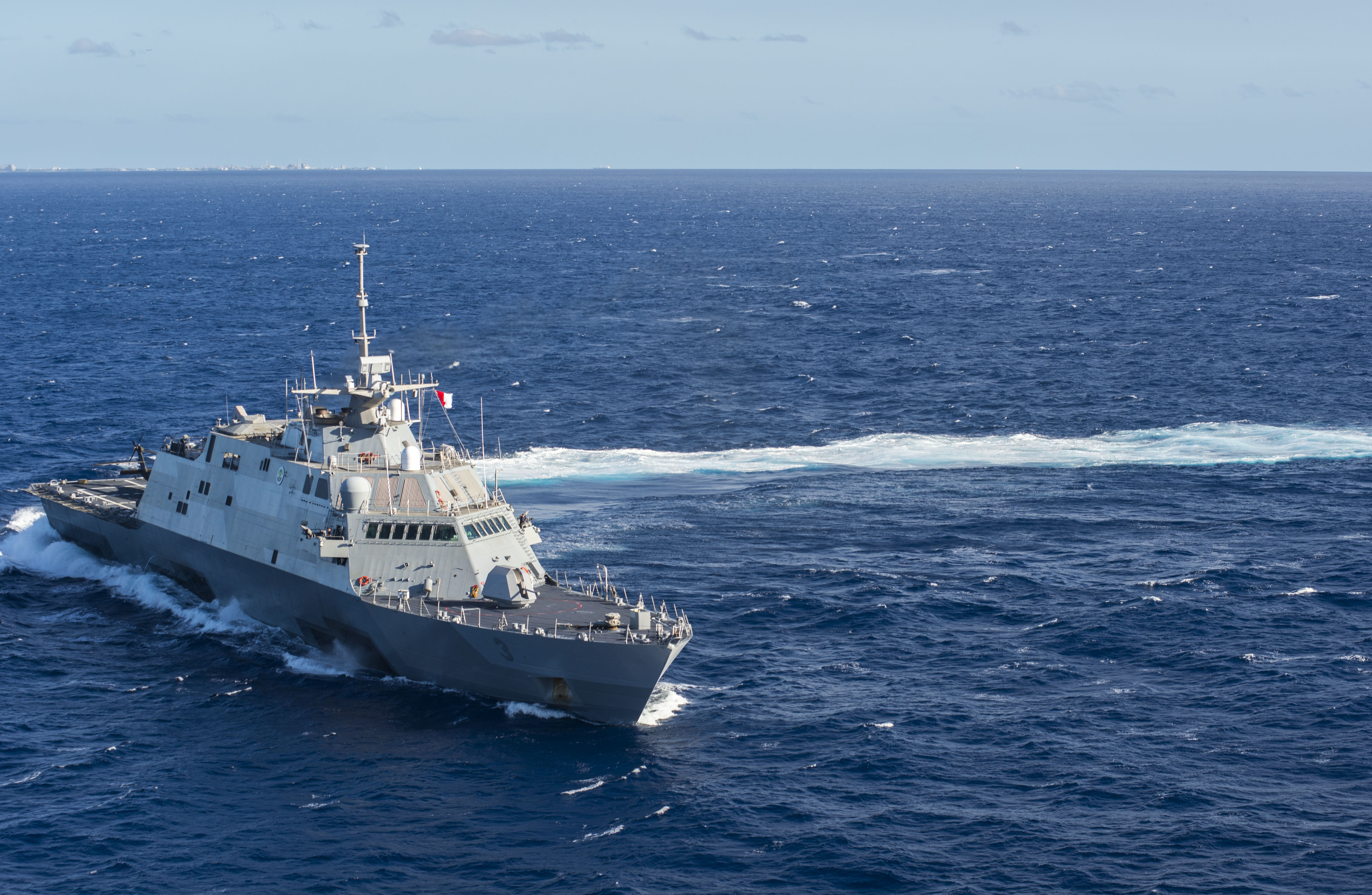 PACIFIC OCEAN (Nov. 25, 2014) The littoral combat ship USS Fort Worth (LCS 3) makes a turn while underway in the pacific Ocean. Fort Worth is providing a sea-going platform for a UH-60A Black Hawk helicopter from the U.S. Army 25th Combat Aviation Brigade to conduct deck landing qualifications off the coast of Hawaii. Fort Worth departed is on a 16-month rotational deployment to Southeast Asia in support of the Navy’s strategic rebalance to the Pacific. (U.S. Navy photo by Mass Communication Specialist 2nd Class Antonio P. Turretto Ramos/Released)